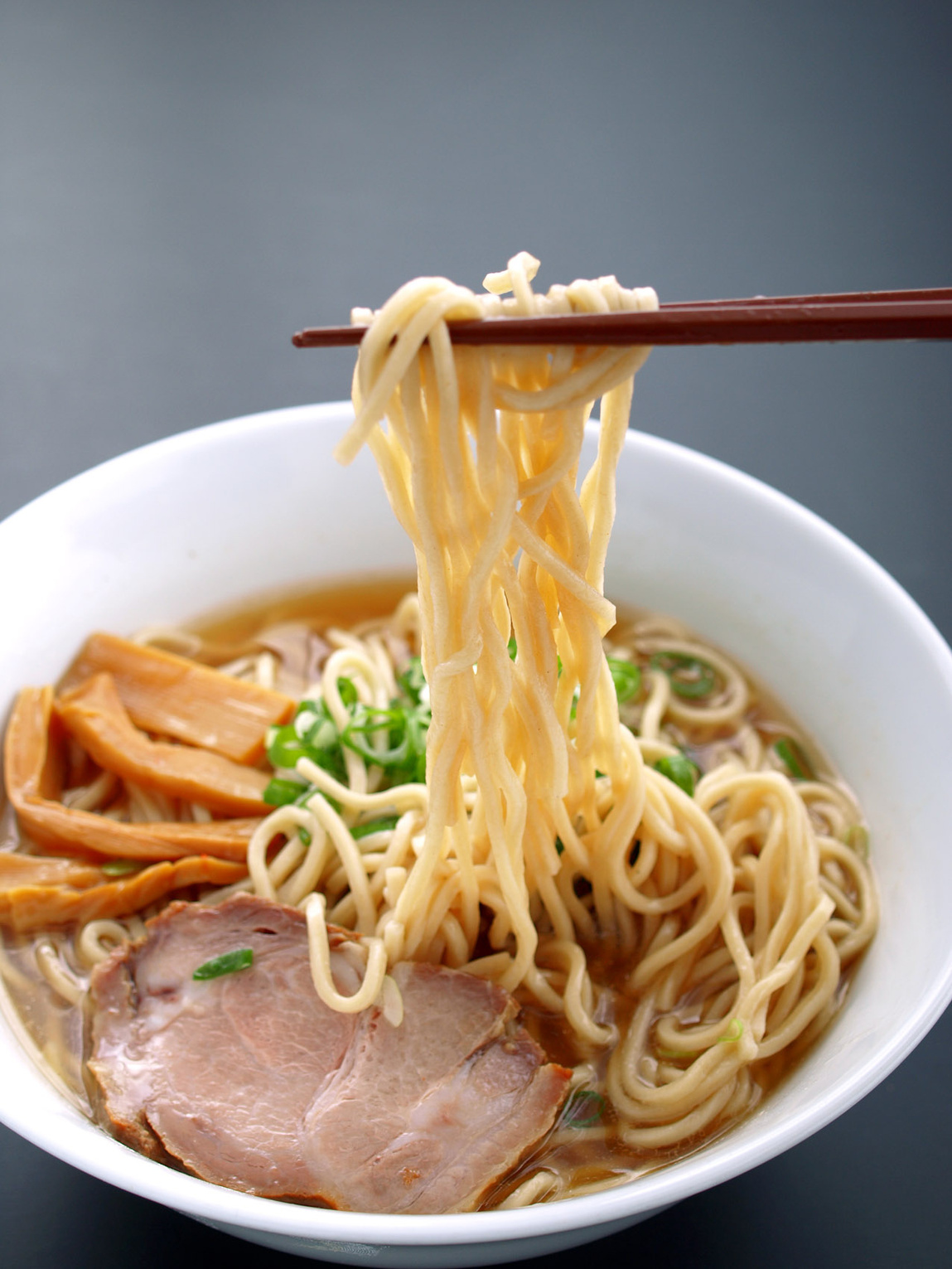 Noodles lifted with chopsticks