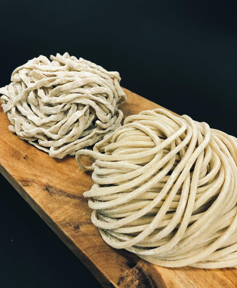 Fresh noodles on a wooden board